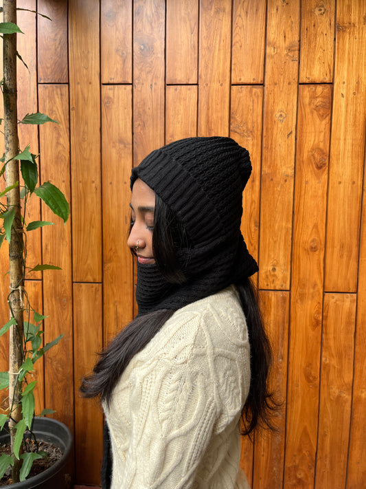 Woman wearing black woollen cap with attached scarf – Madhuri Woollens