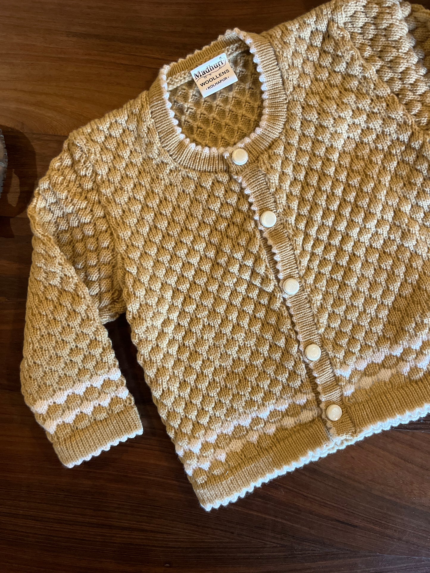Beige baby wool set with sweater, cap and booties from Madhuri Woollens