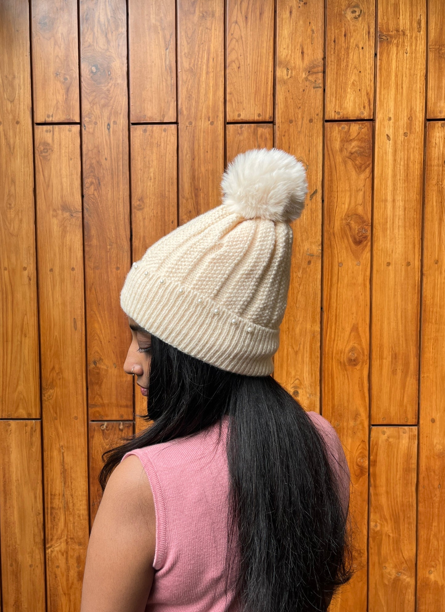 Woman wearing ivory knit cap with pearls and pom-pom – Madhuri Woollens