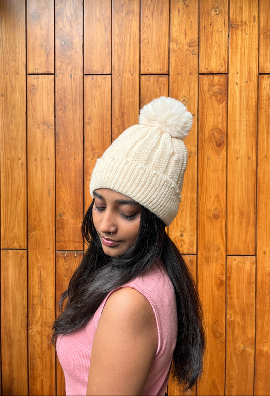 Woman wearing ivory knit cap with pearls and pom-pom – Madhuri Woollens