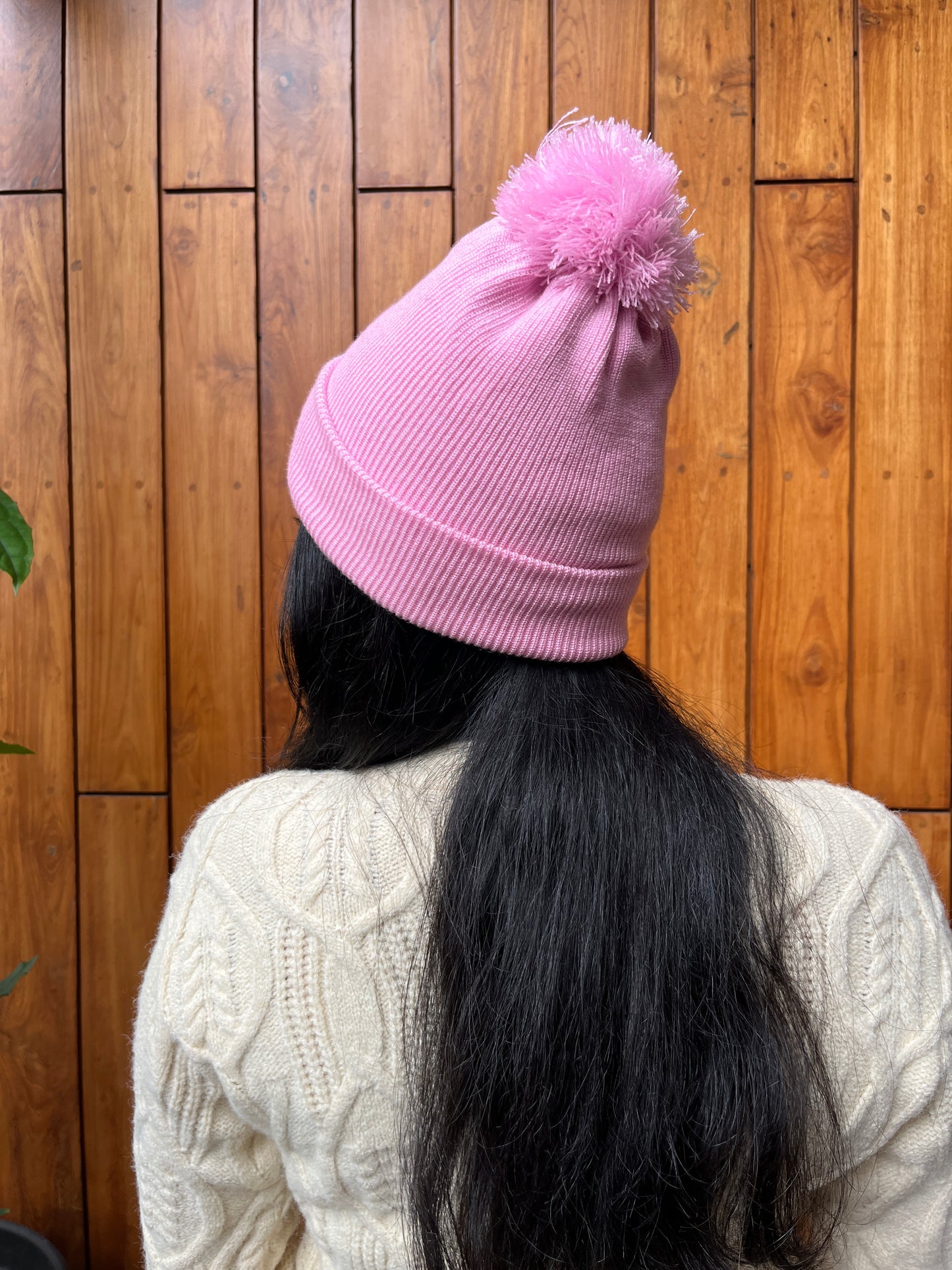 Pink woollen cap with pom-pom worn by woman – Madhuri Woollens