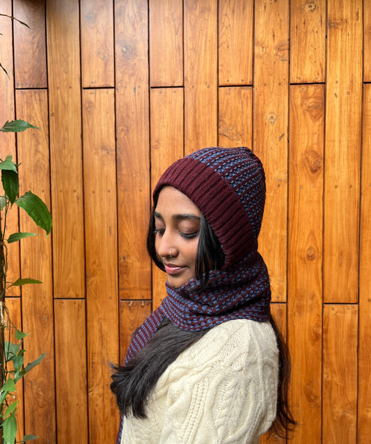 Woman wearing rust and navy blue woollen cap with attached scarf – Madhuri Woollens
