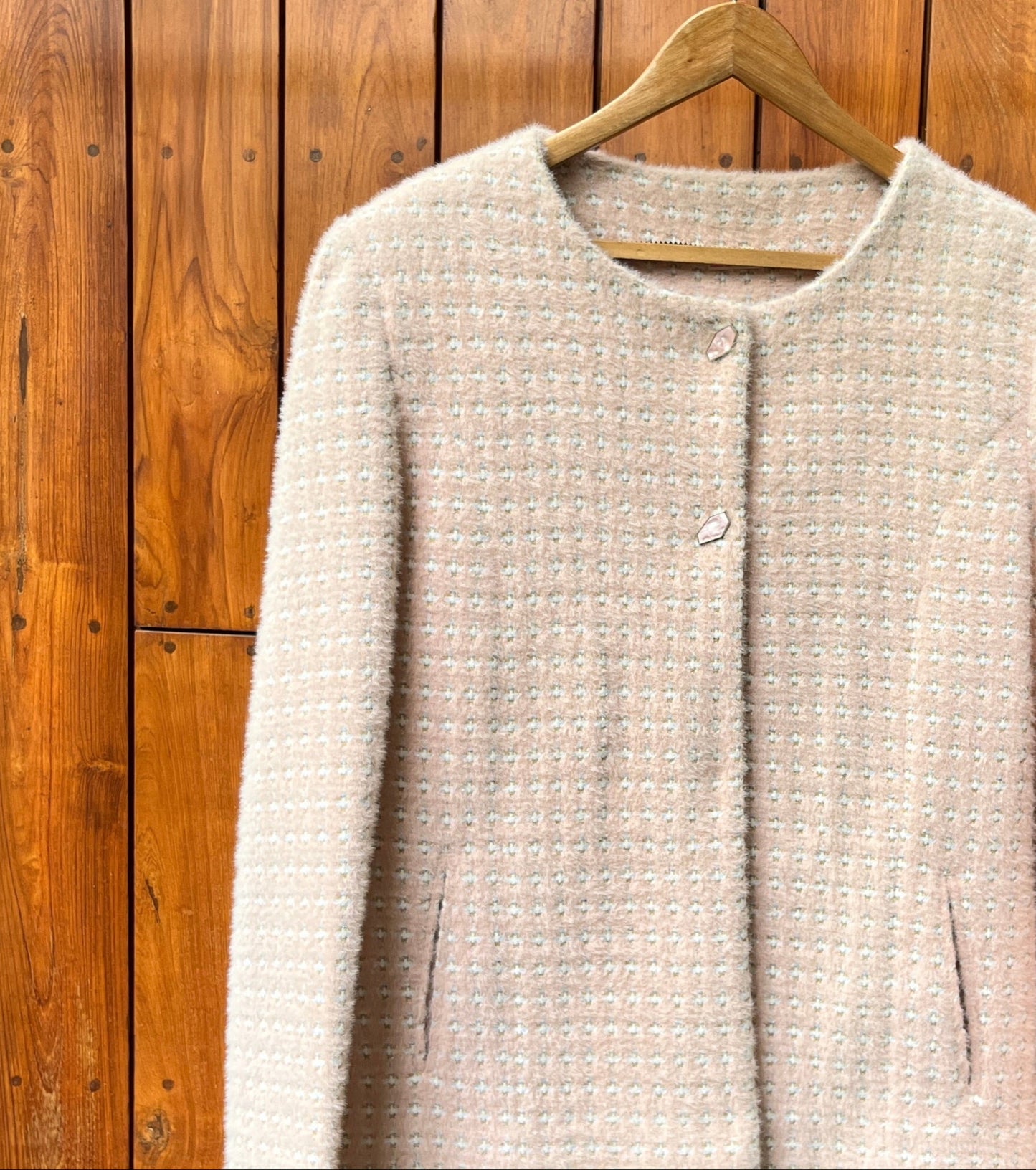 Light pink tweed ladies coat with round neckline and textured finish