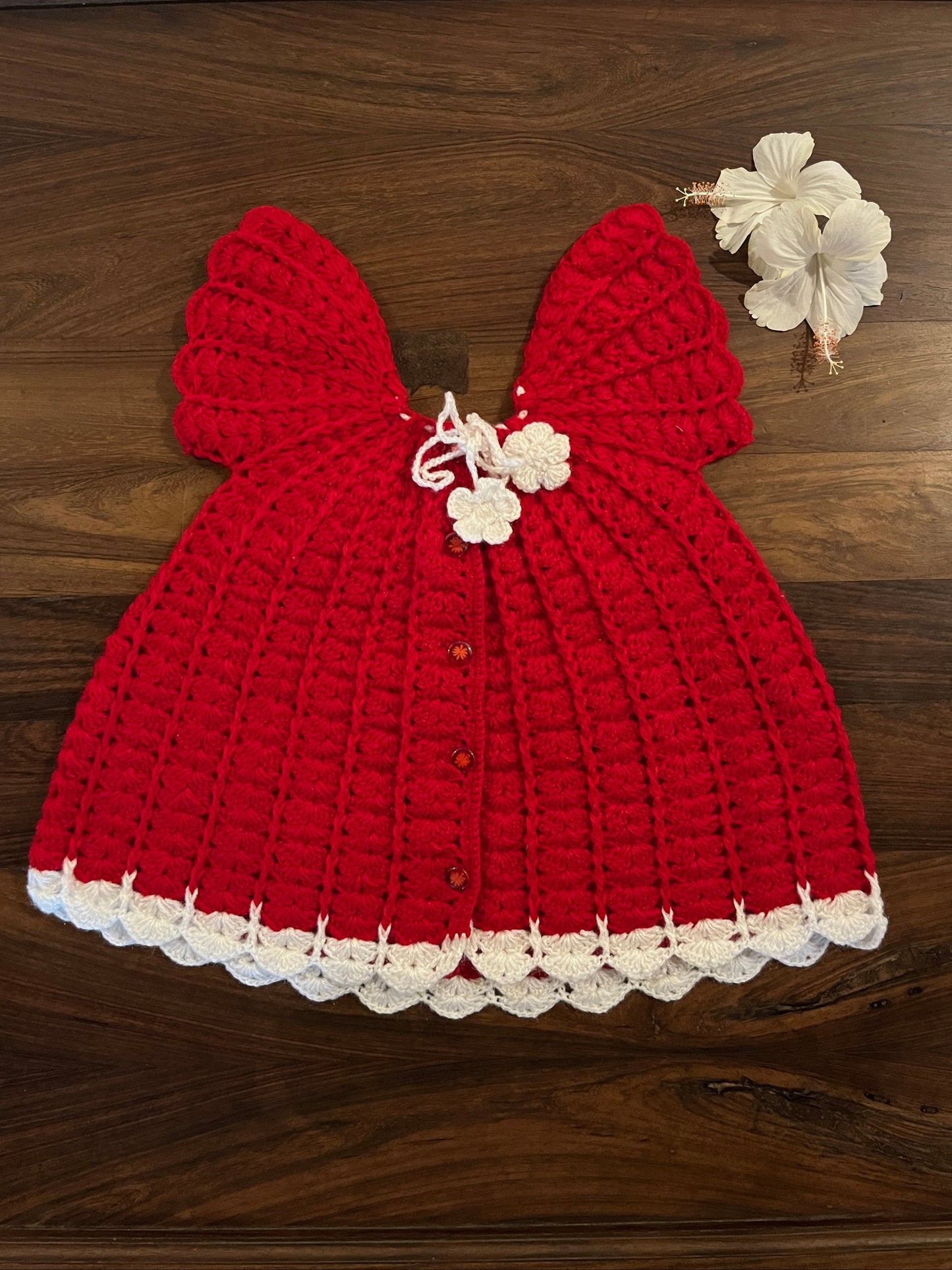 Handmade red and white woollen baby frock with floral ties - Madhuri Woollens