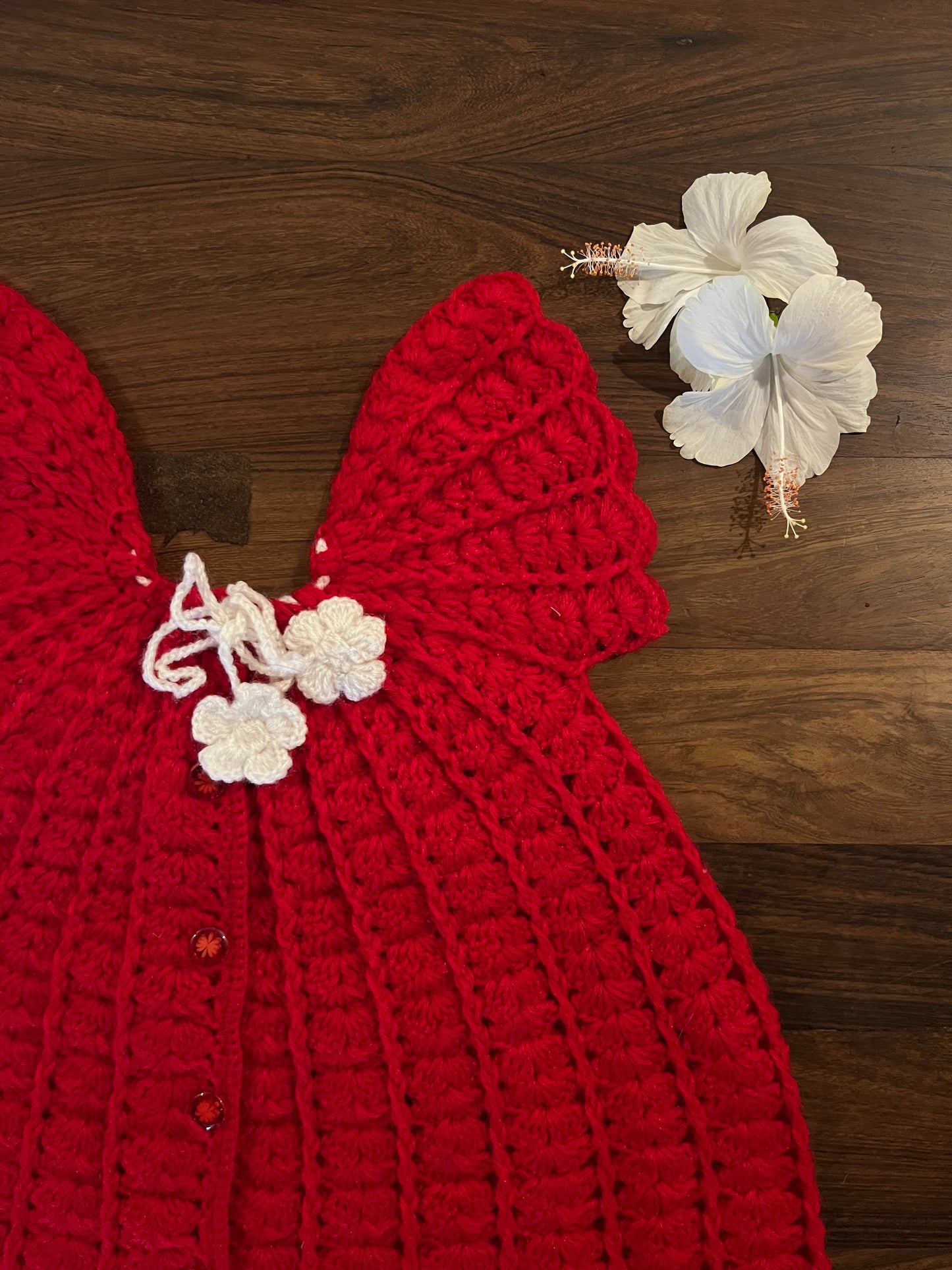 Handmade red and white woollen baby frock with floral ties - Madhuri Woollens