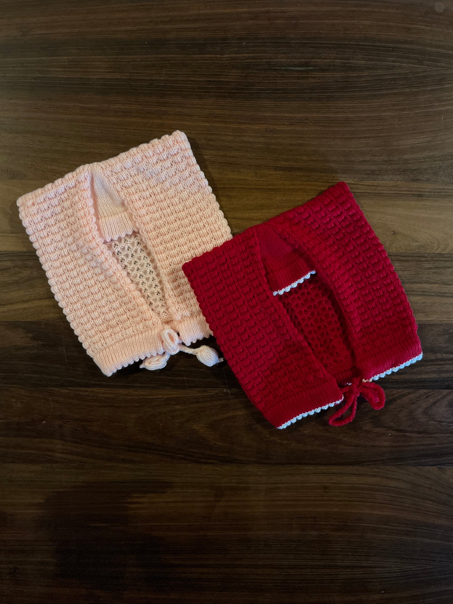 Hand-knitted wool baby sasa caps in baby pink and red