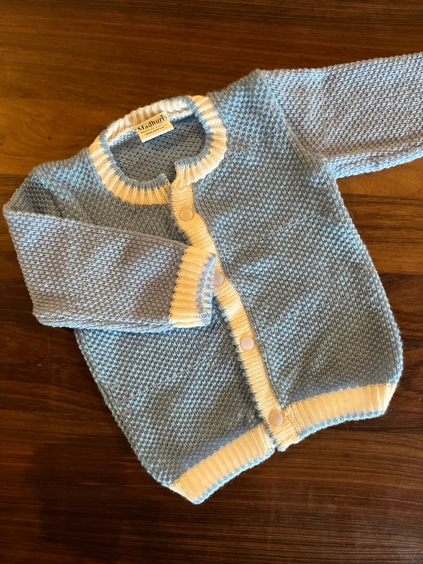 Sky blue baby wool set – sweater, cap, and booties by Madhuri Woollens