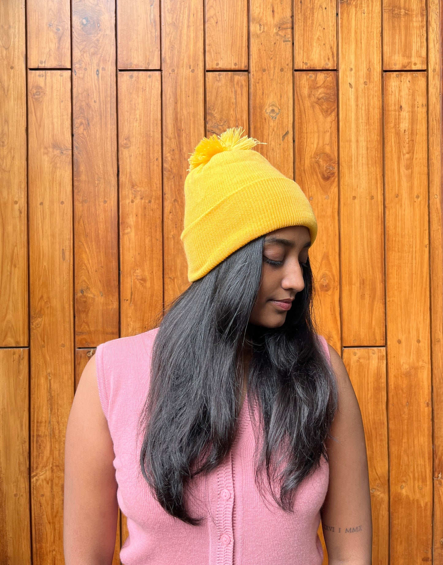 Yellow woollen cap with pom-pom – worn by model – Madhuri Woollens