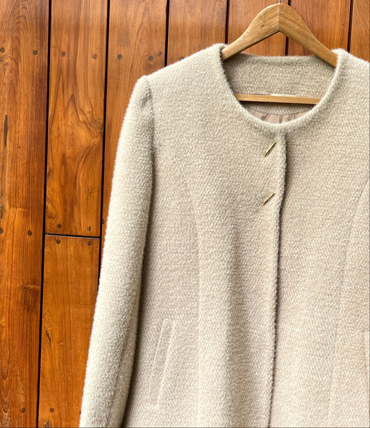 Ivory wool coat with gold buttons and clean tailoring for women