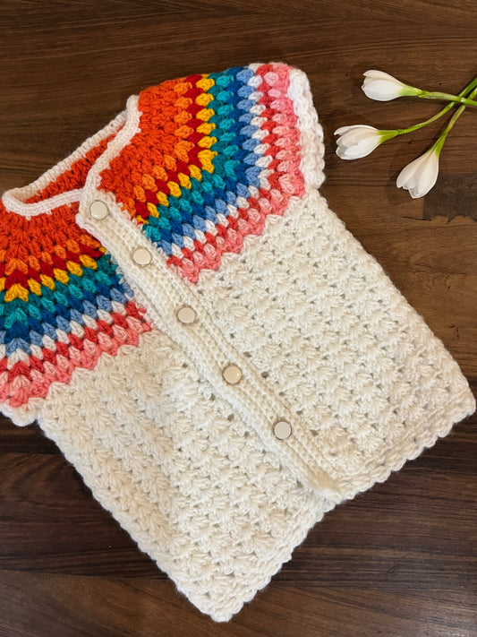 handmade cream and rainbow crochet baby vest for 6–12 months