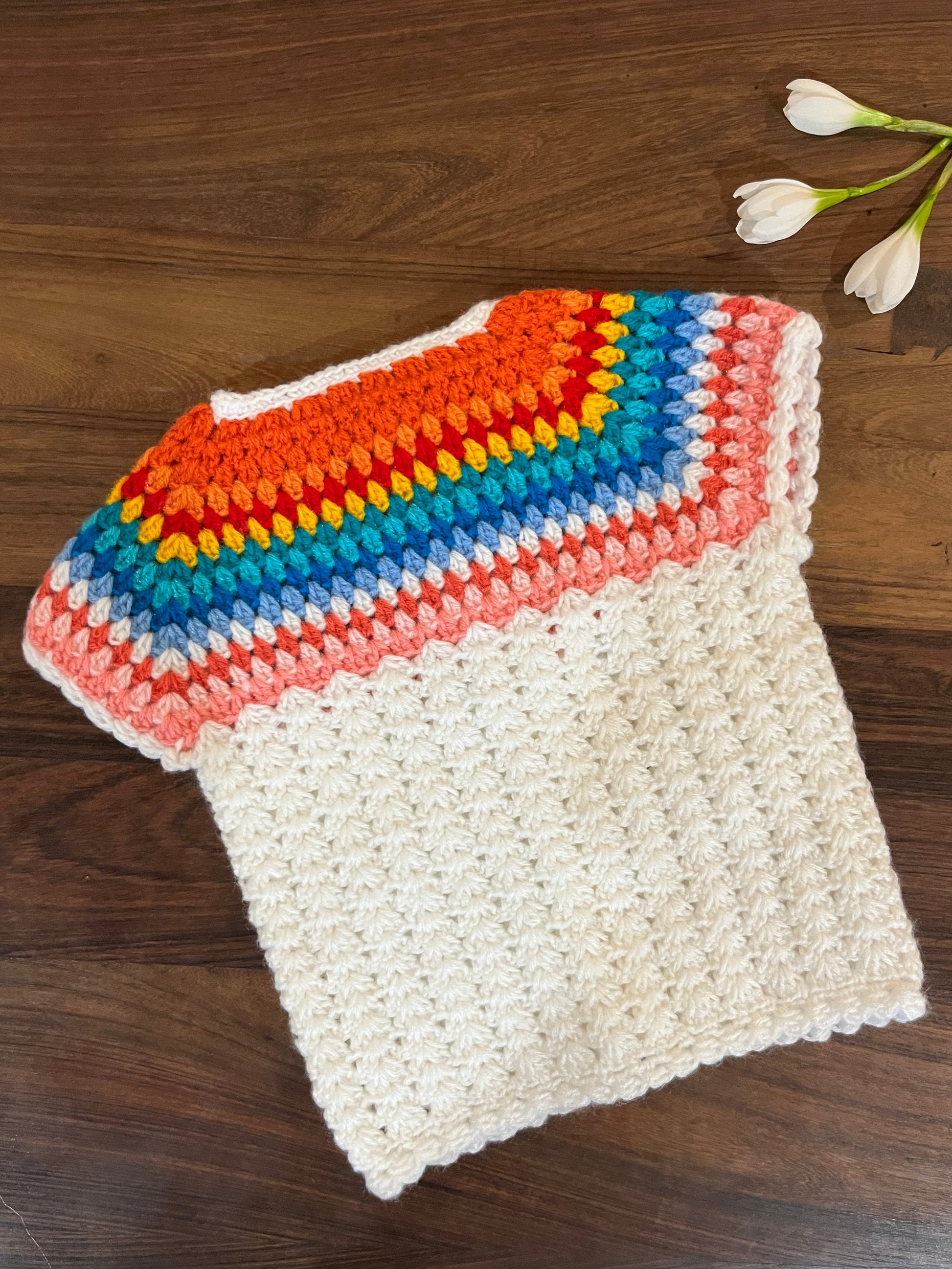 handmade cream and rainbow crochet baby vest for 6–12 months