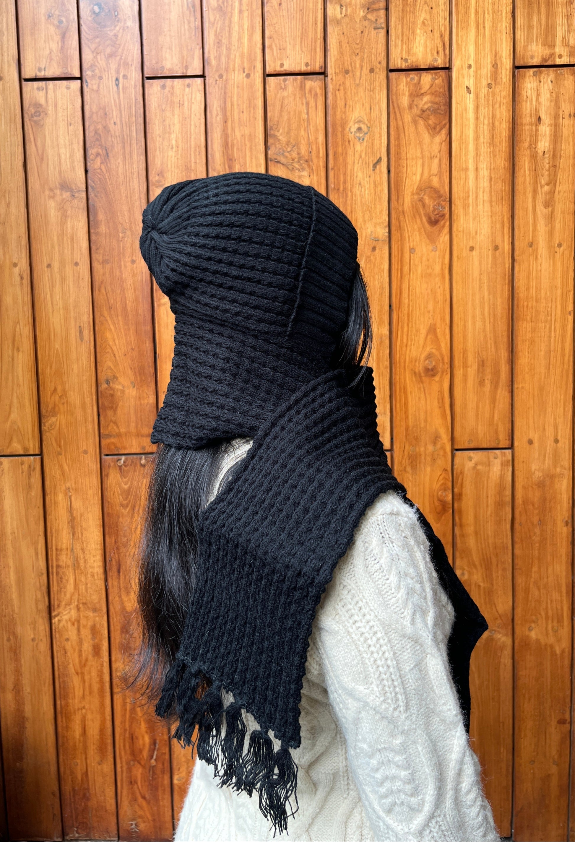 Woman wearing black woollen cap with attached scarf – Madhuri Woollens
