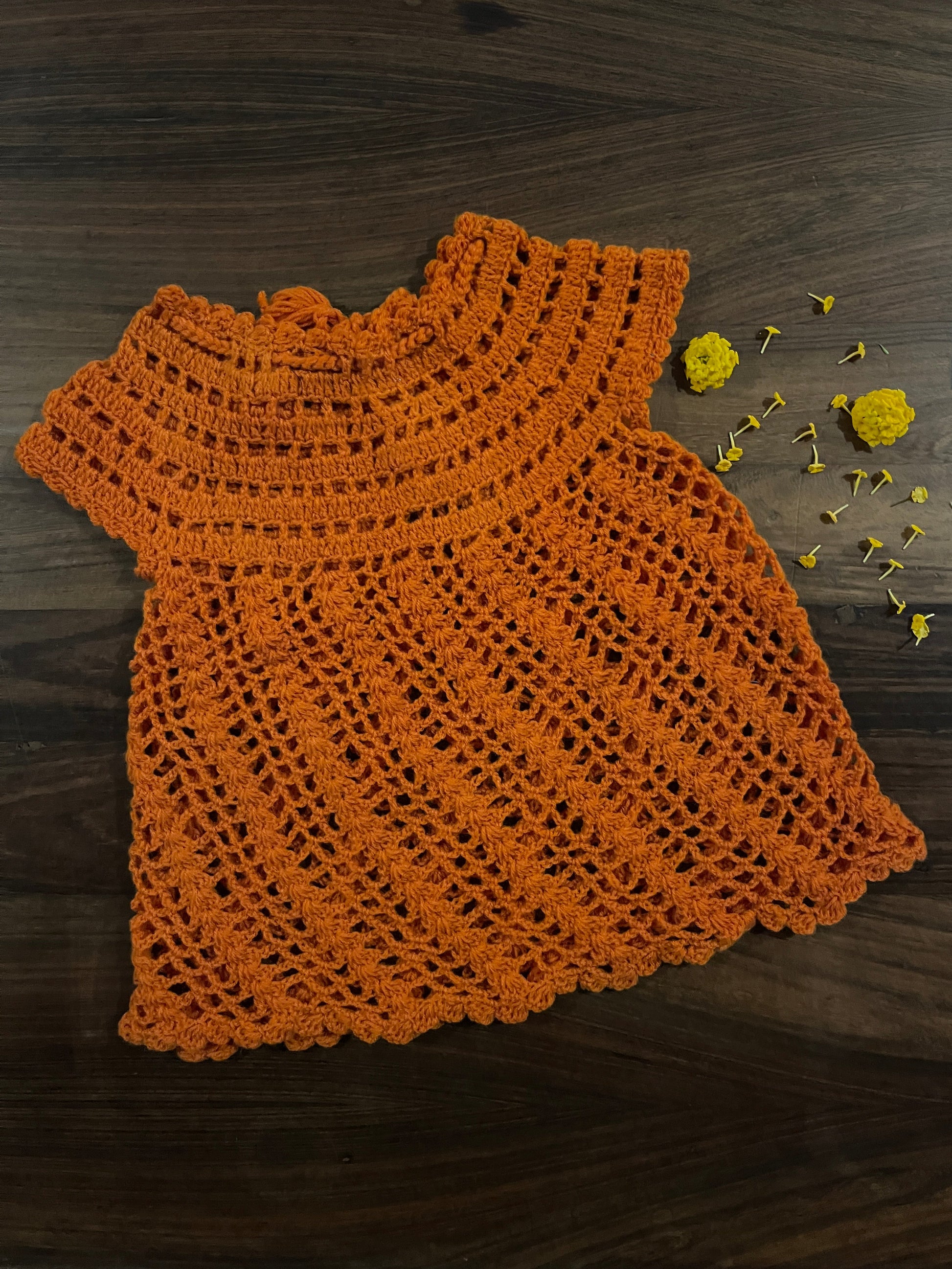 orange handmade crochet baby dress with tassel ties