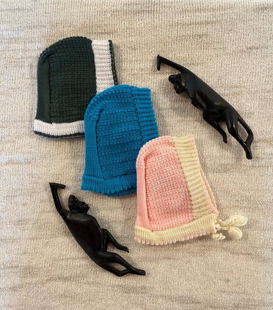 Wool baby bonnets in green, blue, and pink – classic winter caps for newborns and infants – Madhuri Woollens.