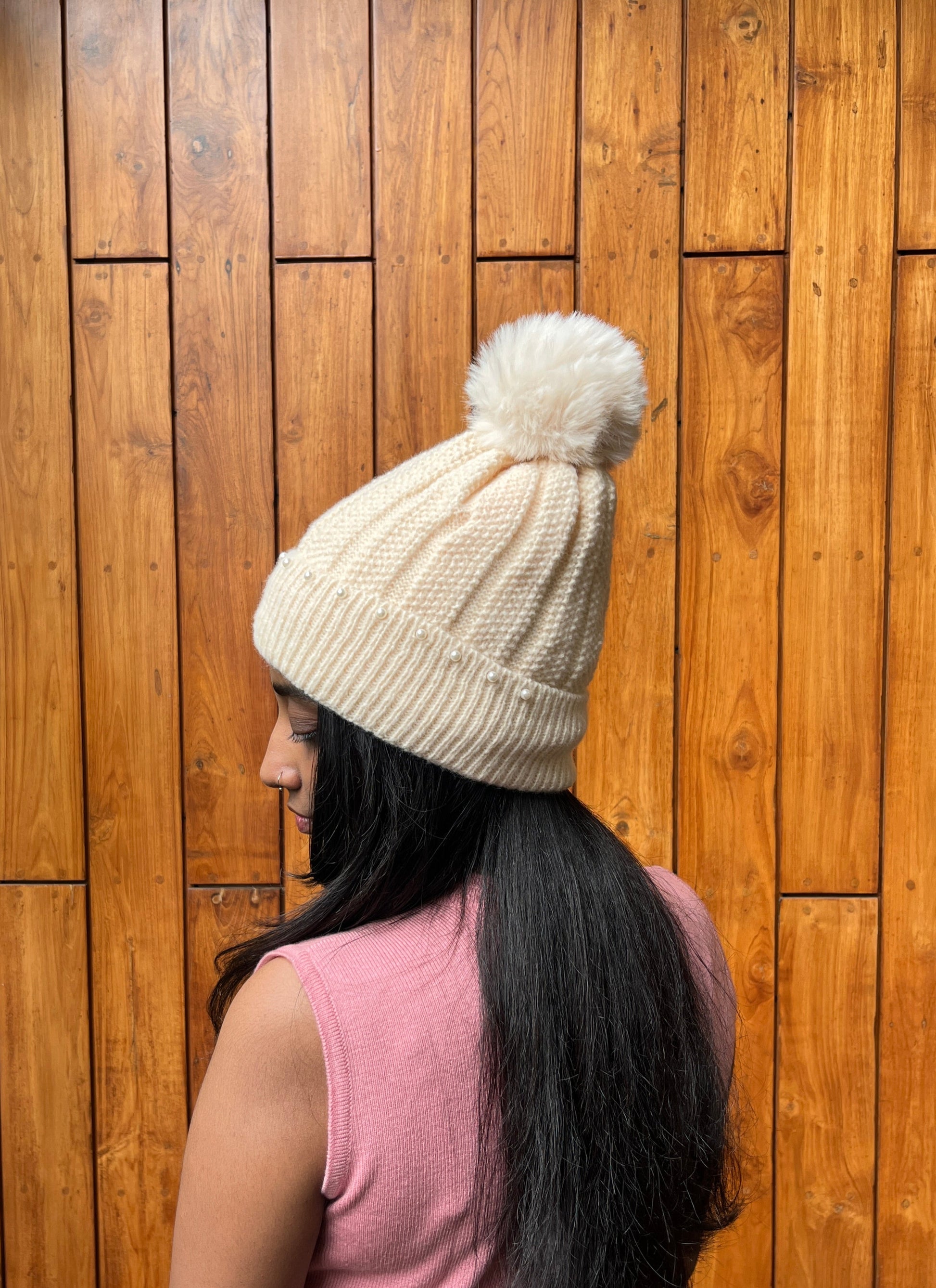 Woman wearing ivory knit cap with pearls and pom-pom – Madhuri Woollens