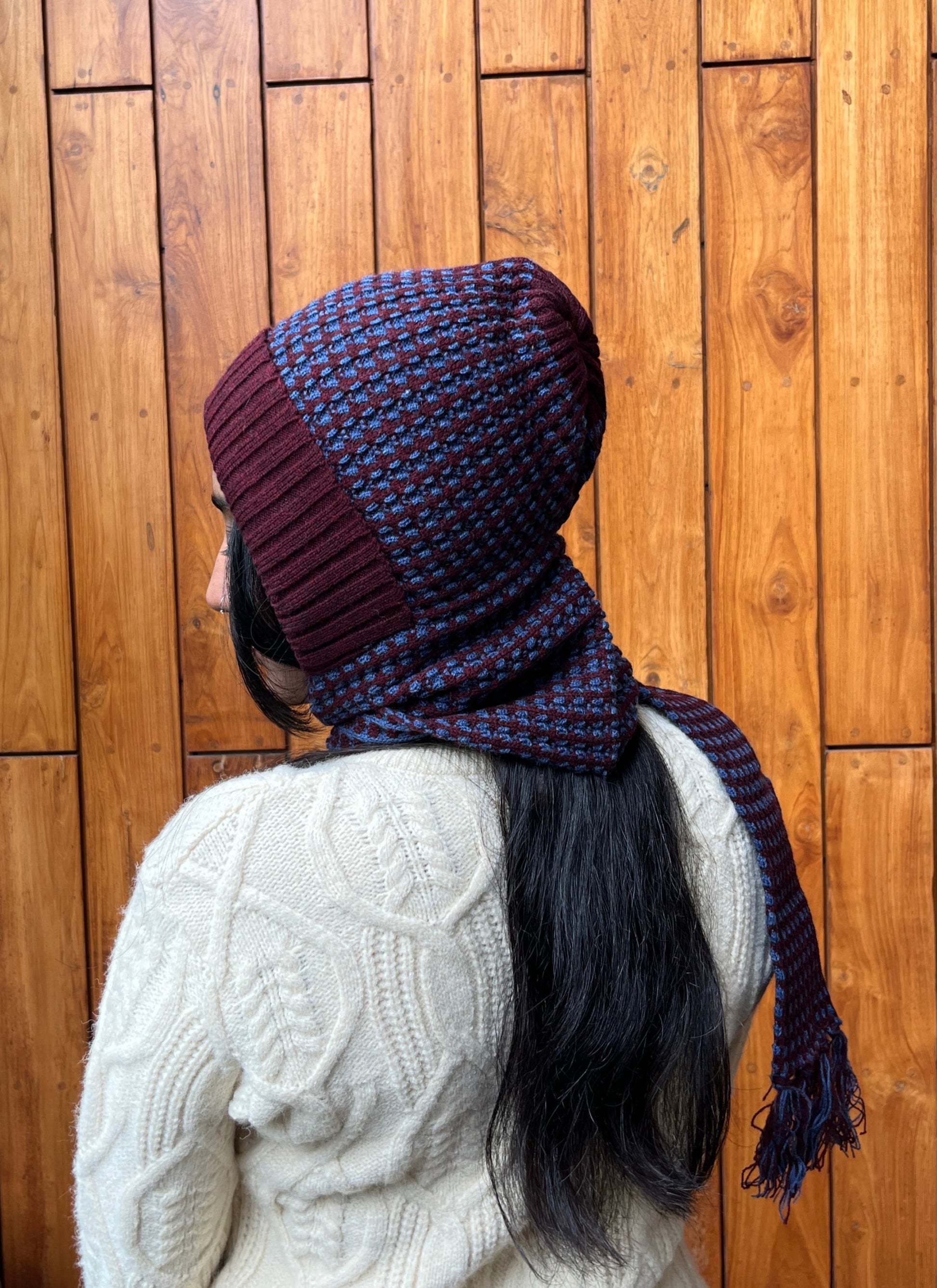 Woman wearing rust and navy blue woollen cap with attached scarf – Madhuri Woollens