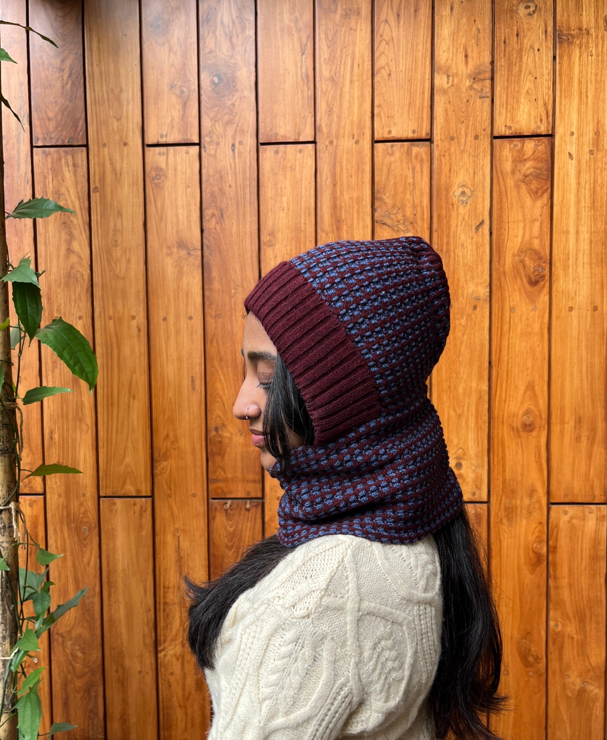Woman wearing rust and navy blue woollen cap with attached scarf – Madhuri Woollens