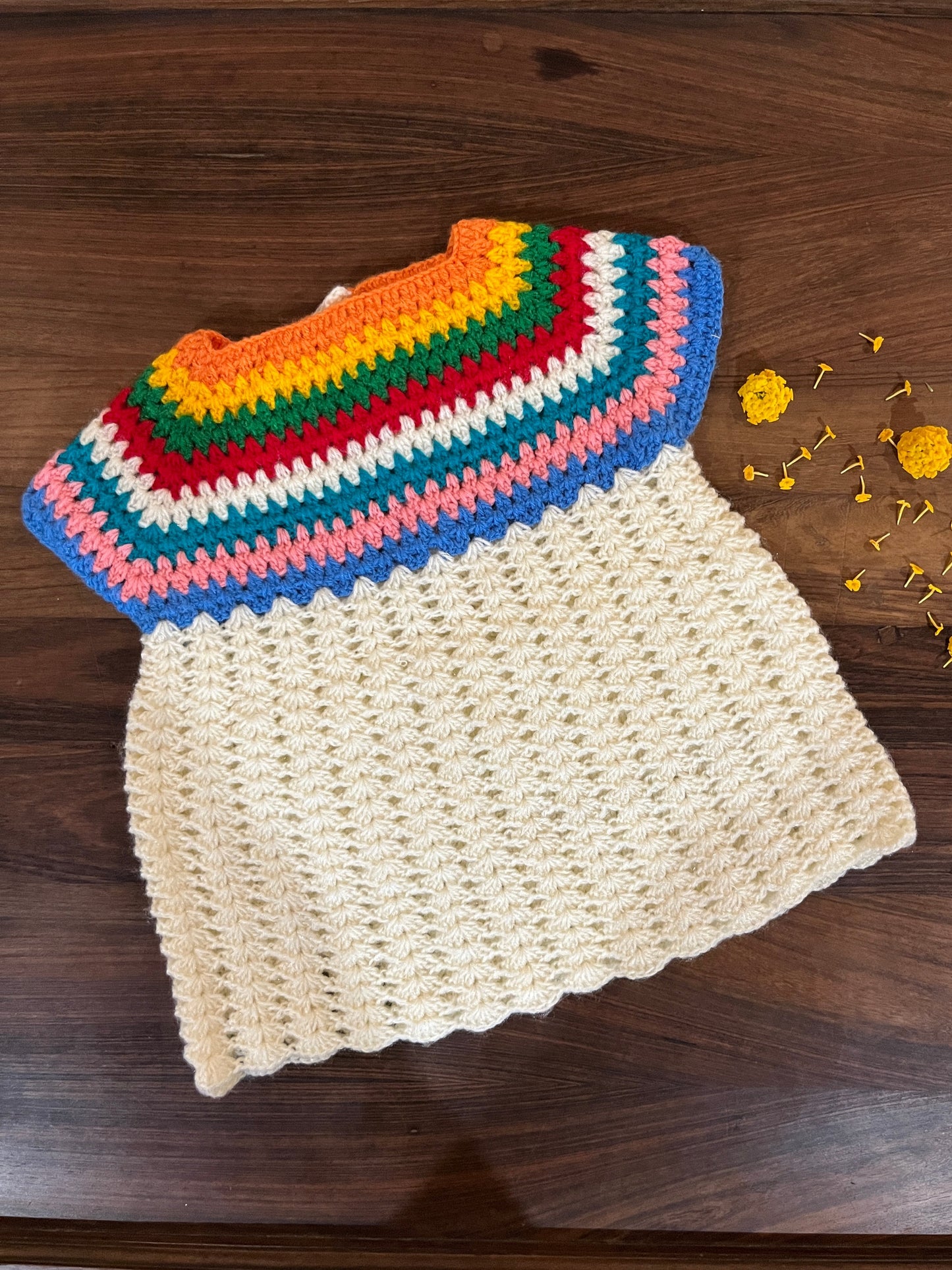 Handmade crochet baby dress with rainbow yoke and cream body for infants 12-24 months