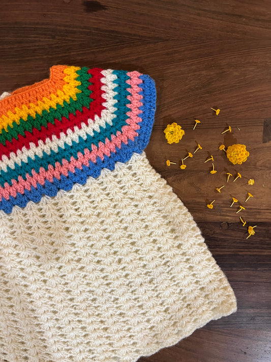 Handmade crochet baby dress with rainbow yoke and cream body for infants 12-24 months