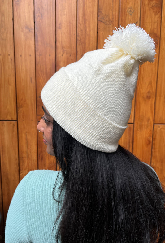Woman wearing soft white woollen cap with pom-pom – Madhuri Woollens