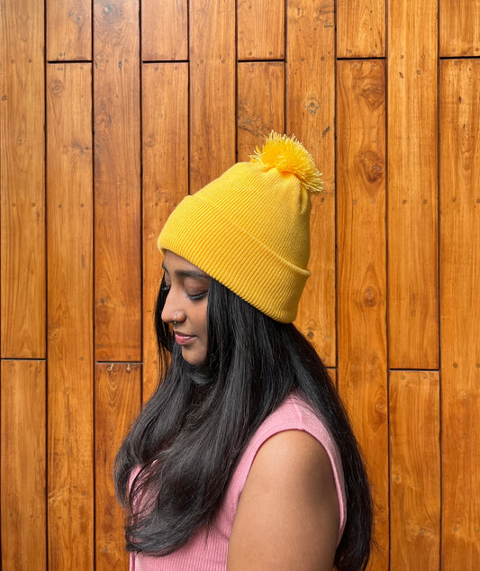 Yellow woollen cap with pom-pom – worn by model – Madhuri Woollens
