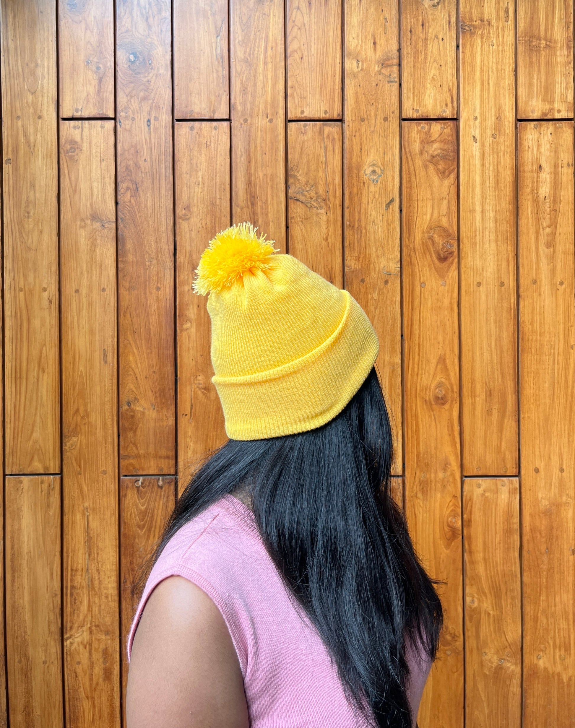 Yellow woollen cap with pom-pom – worn by model – Madhuri Woollens