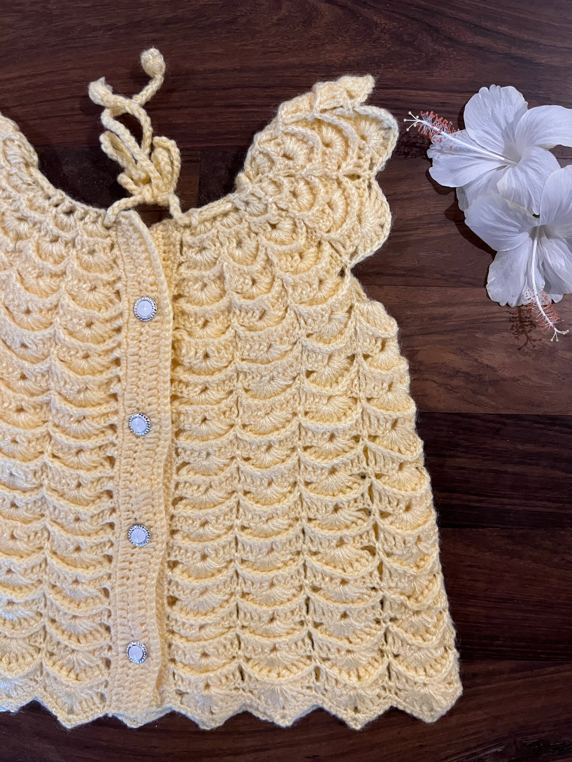 handmade yellow crochet baby dress with scalloped design