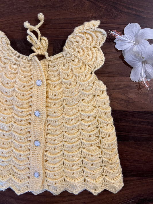 handmade yellow crochet baby dress with scalloped design