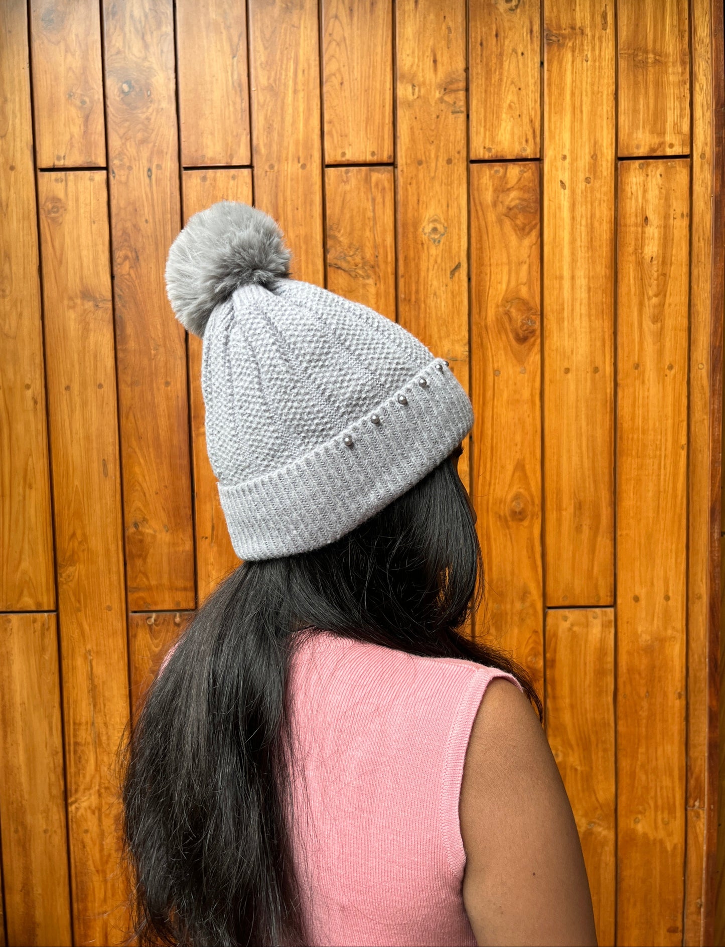 Grey woolen cap with pom-pom and pearl detail – winter accessory by Madhuri Woollens

