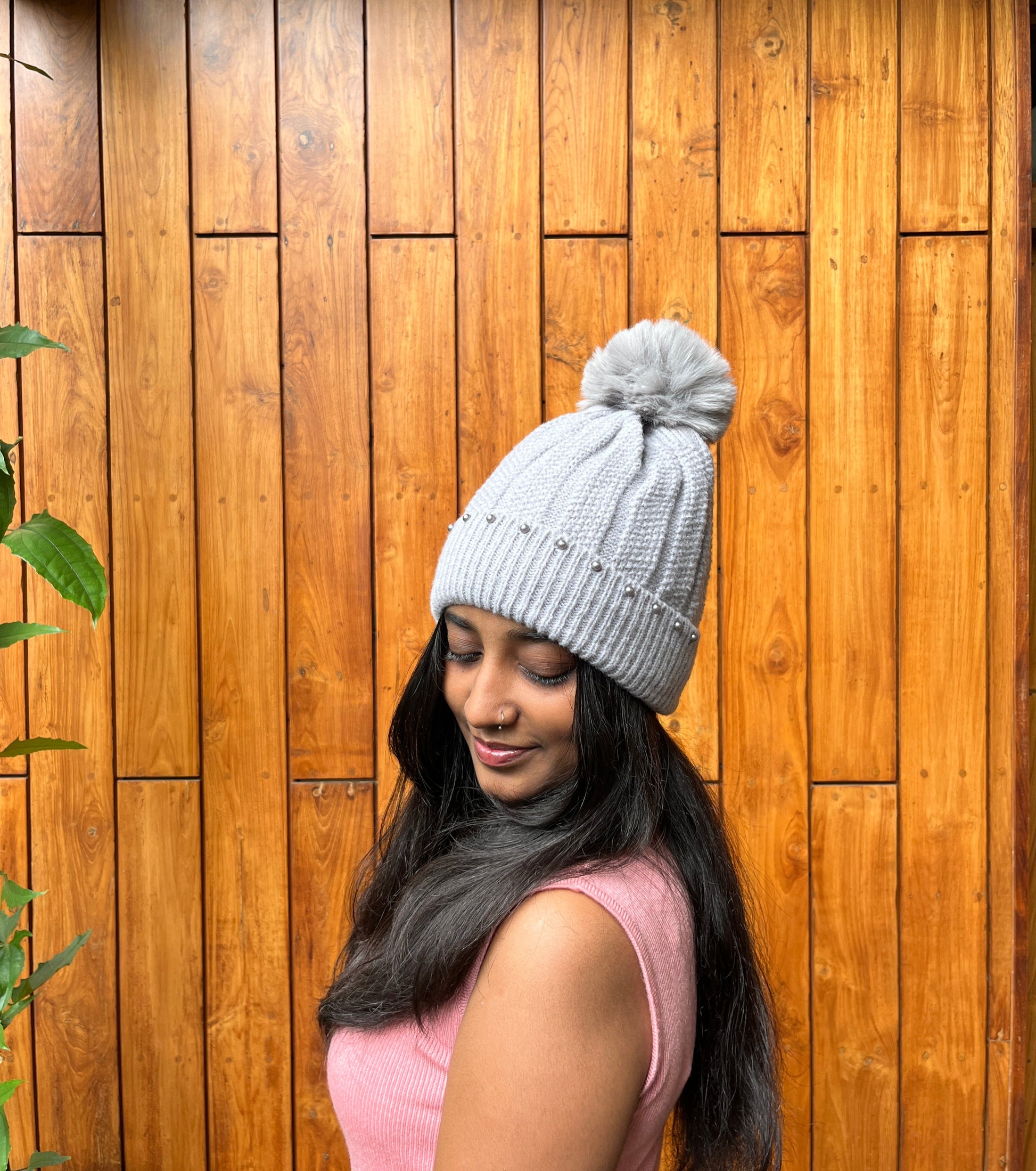 Grey woolen cap with pom-pom and pearl detail – winter accessory by Madhuri Woollens


